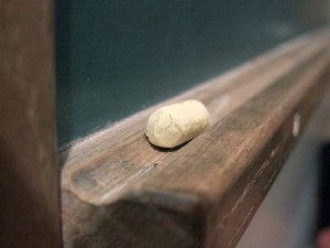well-worn chalk on blackboard tray